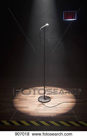 A Microphone Illuminated On A Stage View Large Photo Image Stock Photo - A Microphone Illuminated On A Stage. Fotosearch
