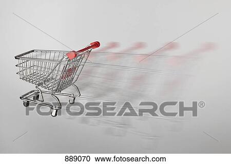 Stock Image - A miniature shopping cart on the move. Fotosearch