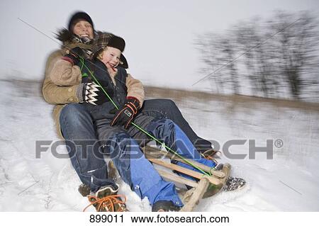 A mother and her son sledding View Large Photo Image Stock Image - A mother and her son sledding. Fotosearch