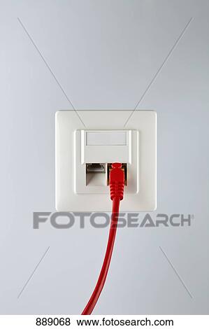 Stock Photo - A network cable plugged into a wall socket. Fotosearch