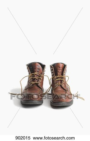 Stock Photography - A pair of worn work boots. Fotosearch