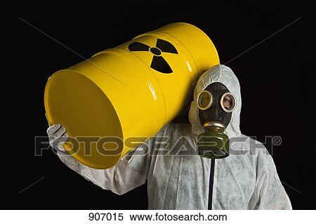 Stock Photography - A Person Carrying A Radioactive Barrel And Wearing Protective Clothing. Fotosearch