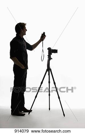 A photographer using a light meter View Large Photo Image Stock Photo - A photographer using a light meter. Fotosearch