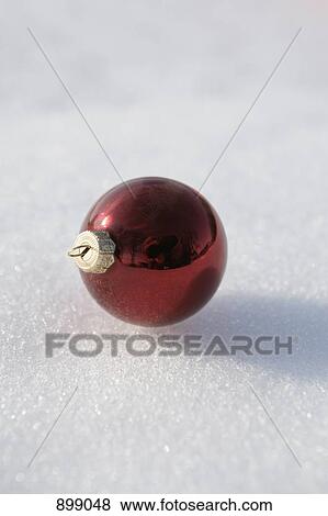 A red Christmas ball ornament on snow View Large Photo Image Stock Photo - A red Christmas ball ornament on snow. Fotosearch