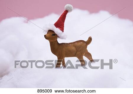 A reindeer figurine standing in fake snow View Large Photo Image Stock Photo - A reindeer figurine standing in fake snow. Fotosearch