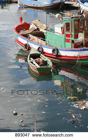 A rowboat tied to a tugboat, Setubal, Portugal View Large Photo Image Stock Photo - A rowboat tied to a tugboat, Setubal, Portugal. Fotosearch