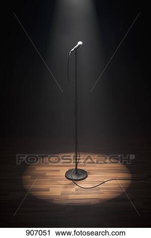 Stock Image - A Spot lit Microphone. Fotosearch