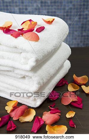 A stack of folded towels with rose petals View Large Photo Image Stock Photo - A stack of folded towels with rose petals. Fotosearch