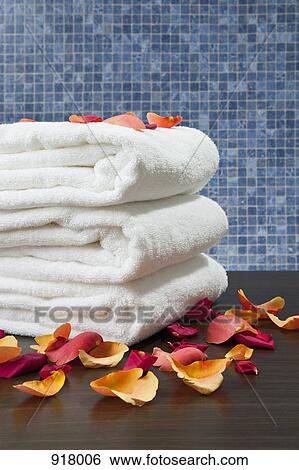 A stack of folded towels with rose petals View Large Photo Image Stock Photograph - A stack of folded towels with rose petals. Fotosearch