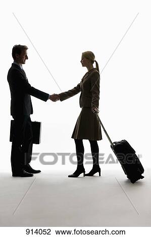 A traveling businessman and businesswoman shaking hands View Large Photo Image Stock Image - A traveling businessman and businesswoman shaking hands . Fotosearch