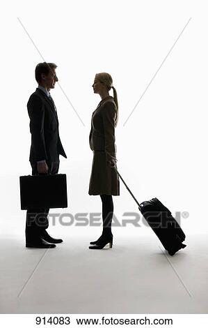 A traveling businessman and businesswoman standing, face to face View Large Photo Image Stock Image - A traveling businessman and businesswoman standing, face to face. Fotosearch
