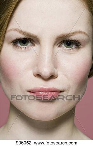 A woman grimacing in irritation, extreme close up View Large Photo Image Stock Image - A woman grimacing in irritation, extreme close up. Fotosearch