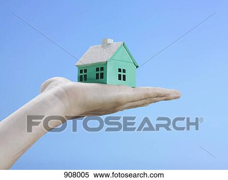 A woman holding a small house on her palm, focus on the hand View Large Photo Image Stock Photography - A woman holding a small house on her palm, focus on the hand. Fotosearch