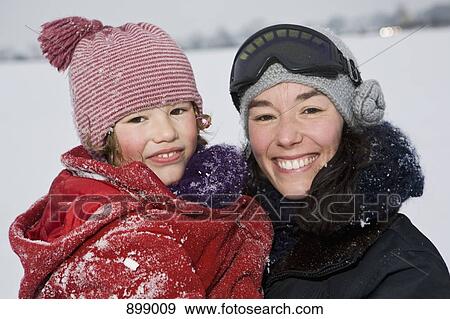 A woman holding her daughter, outdoors, portrait View Large Photo Image Stock Photo - A woman holding her daughter, outdoors, portrait. Fotosearch