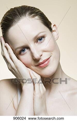 A woman looking serenely into the camera View Large Photo Image Picture - A woman looking serenely into the camera. Fotosearch