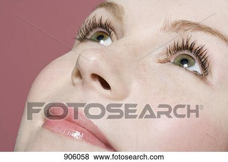Stock Photo - A woman looking up, extreme close up, detail of face. Fotosearch