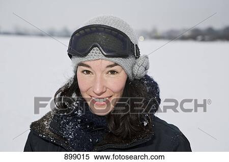 Stock Photography - A woman outdoors in winter, head and shoulders, portrait. Fotosearch