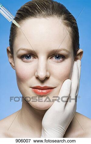 Stock Photo - A woman receiving a Botox injection. Fotosearch