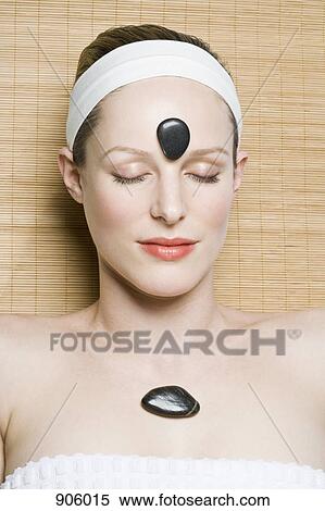 A woman receiving hot stone therapy View Large Photo Image Stock Photography - A woman receiving hot stone therapy. Fotosearch