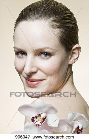 Stock Photo - A woman smiling at the camera, head and shoulders. Fotosearch
