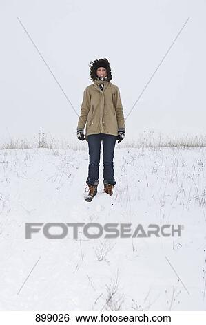 A woman standing on a snowy hill, portrait View Large Photo Image Stock Photograph - A woman standing on a snowy hill, portrait. Fotosearch