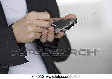 A woman using an electronic organizer and digitized pen, detail of hands View Large Photo Image Stock Image - A woman using an electronic organizer and digitized pen, detail of hands. Fotosearch