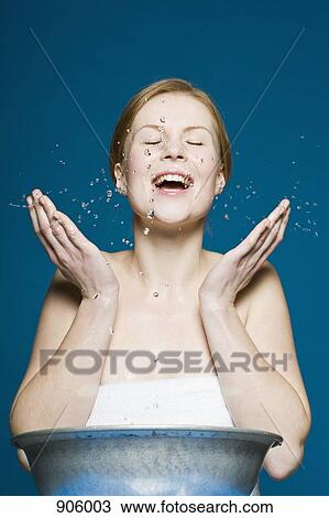 A woman washing her face View Large Photo Image Stock Image - A woman washing her face. Fotosearch