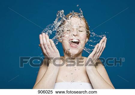 A woman washing her face View Large Photo Image Stock Photography - A woman washing her face. Fotosearch