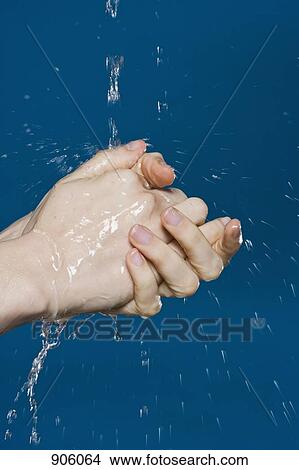 Picture - A woman washing her hands, detail shot of hands. Fotosearch