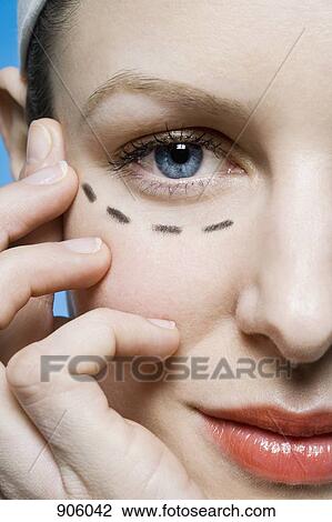 A woman with a plastic surgery guide drawn under her eye, extreme close up View Large Photo Image Stock Image - A woman with a plastic surgery guide drawn under her eye, extreme close up. Fotosearch