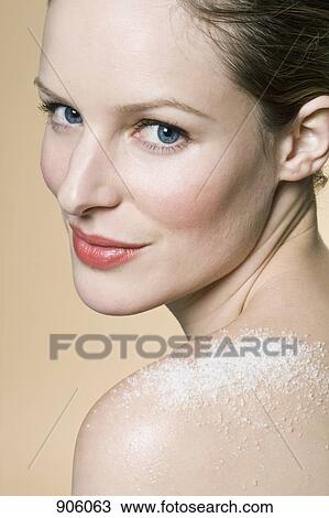 Stock Image - A woman with mineral salt on her shoulder. Fotosearch