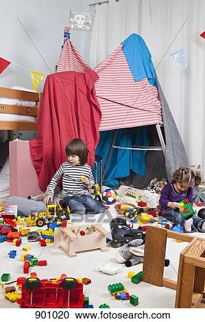 A young boy and girl playing in a bedroom View Large Photo Image Stock Image - A young boy and girl playing in a bedroom. Fotosearch