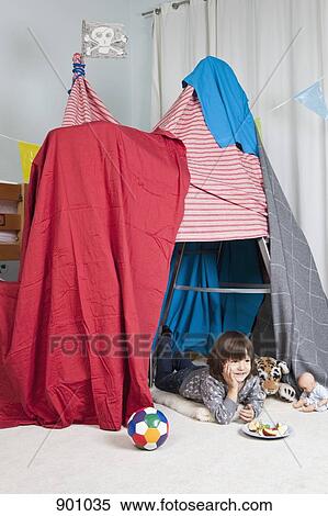 A young boy in a fort having a snack View Large Photo Image Stock Photography - A young boy in a fort having a snack. Fotosearch