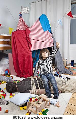 A young boy sitting on a tied up man in a child's playroom View Large Photo Image Stock Image - A young boy sitting on a tied up man in a child's playroom. Fotosearch