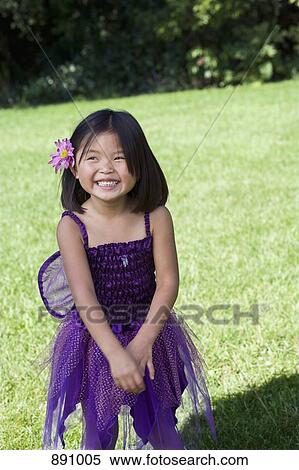 A young girl in a fairy costume standing in a back yard View Large Photo Image Stock Photography - A young girl in a fairy costume standing in a back yard. Fotosearch