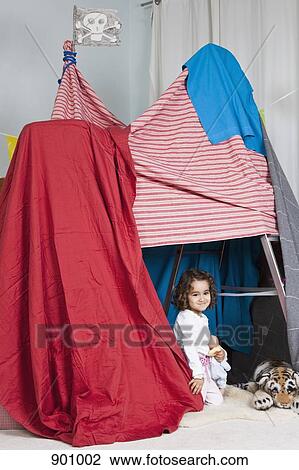 Stock Image - A young girl playing in a fort. Fotosearch