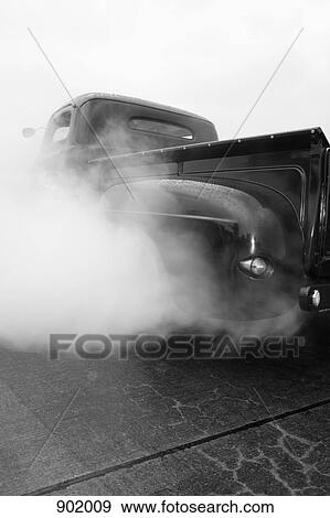 An old-fashioned pick-up truck revving engine creating exhaust to come out View Large Photo Image Stock Photo - An old-fashioned pick-up truck revving engine creating exhaust to come out. Fotosearch