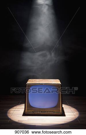 Stock Photograph - An Old Fashioned Television Spot Lit On A Stage. Fotosearch