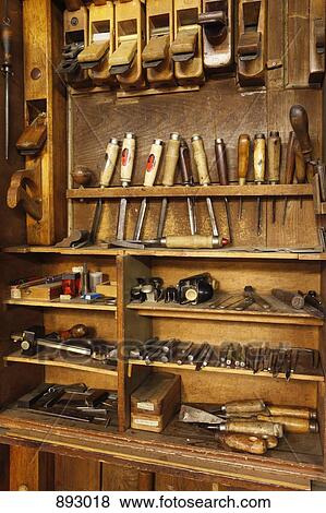 Stock Photo - Antique woodworkers cabinet with various tools. Fotosearch