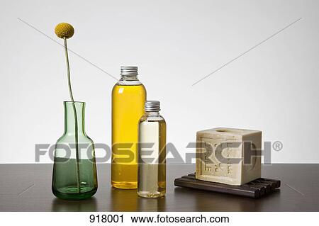 Aromatherapy oil, a bar of soap, and a vase with a Billybutton Daisy (Craspedia) View Large Photo Image Stock Image - Aromatherapy oil, a bar of soap, and a vase with a Billybutton Daisy (Craspedia). Fotosearch