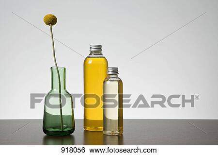 Aromatherapy oil and a vase with a Billybutton Daisy (Craspedia) View Large Photo Image Stock Photograph - Aromatherapy oil and a vase with a Billybutton Daisy (Craspedia). Fotosearch