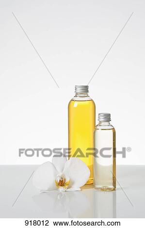 Aromatherapy oil and an orchid View Large Photo Image Stock Image - Aromatherapy oil and an orchid. Fotosearch