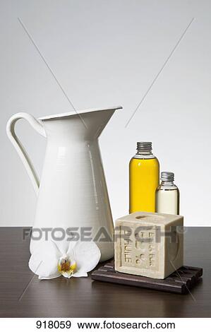 Aromatherapy oil, soap, a pitcher and an orchid View Large Photo Image Stock Photo - Aromatherapy oil, soap, a pitcher and an orchid. Fotosearch