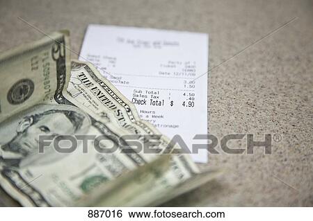 Cash and a receipt on a counter View Large Photo Image Stock Photograph - Cash and a receipt on a counter. Fotosearch