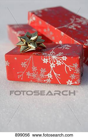 Christmas presents on the snow View Large Photo Image Stock Photograph - Christmas presents on the snow. Fotosearch