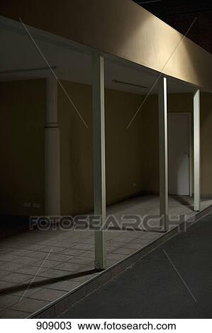 Stock Image - Detail of a building arcade at night. Fotosearch