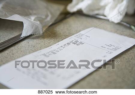 Stock Photography - Detail of a cafe receipt on a counter. Fotosearch