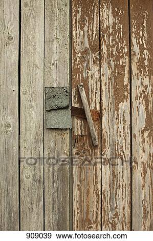 Stock Photo - Detail of a latch on a wooden structure. Fotosearch