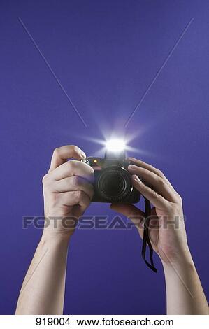 Picture - Detail of a man taking a photograph with a camera. Fotosearch
