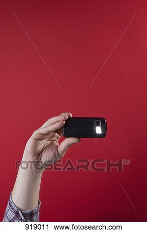 Detail of a man taking a photograph with a mobile phone View Large Photo Image Stock Image - Detail of a man taking a photograph with a mobile phone. Fotosearch
